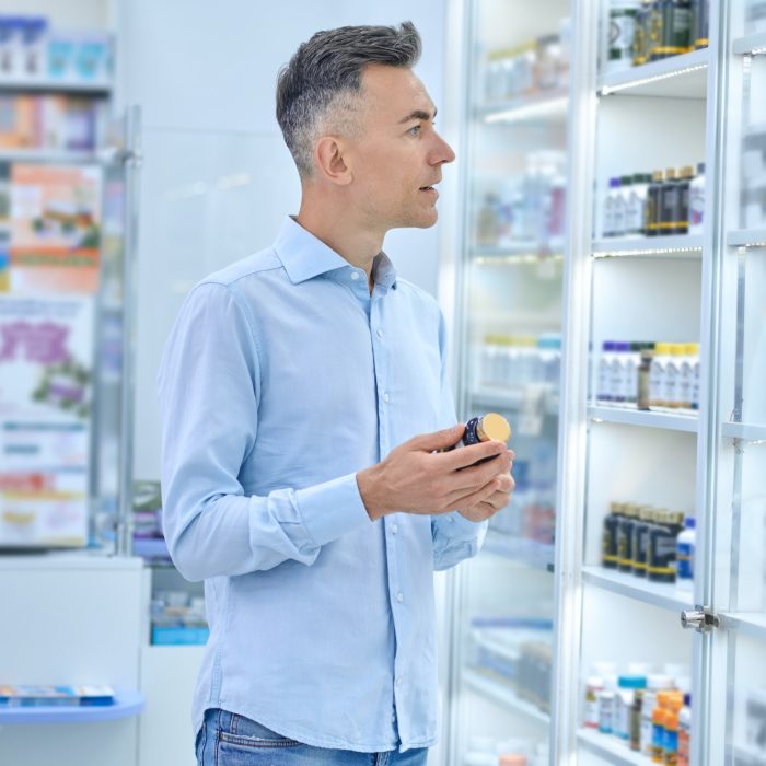A man choosing medicines in a drugstore
