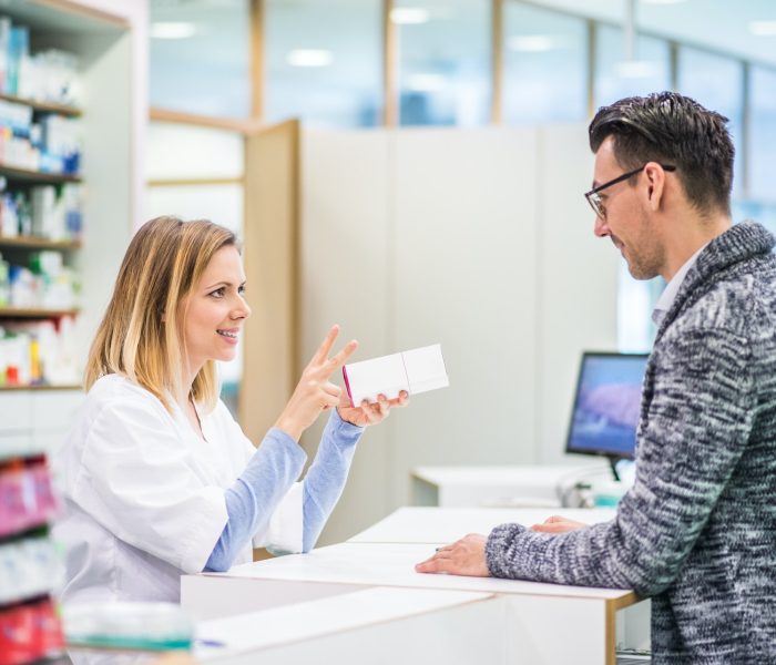 female-pharmacist-serving-a-male-customer-.jpg