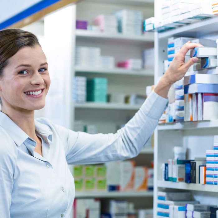 Pharmacist checking a medicine in pharmacy