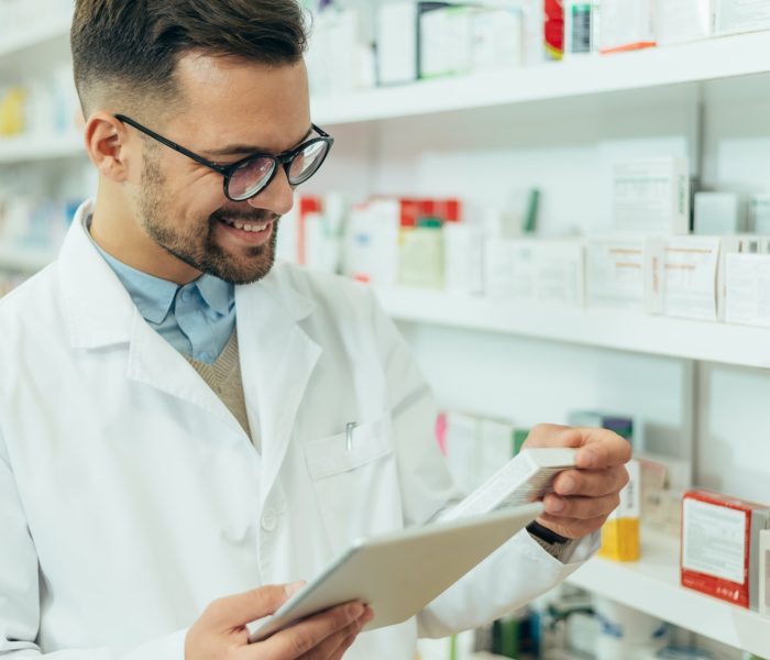 Portrait of a handsome pharmacist working in a pharmacy